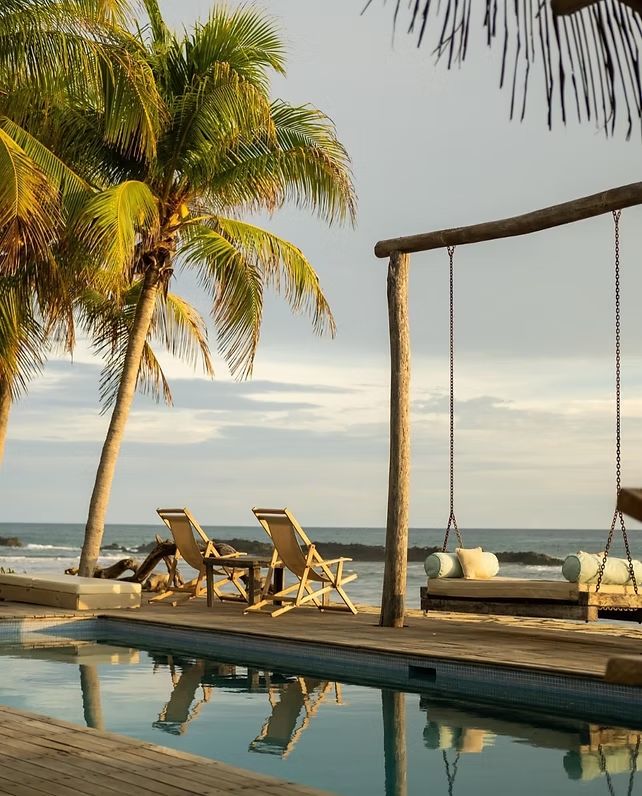 A wide shot of the pool and beach chairs at Mandla in El Transito, Nicaragua