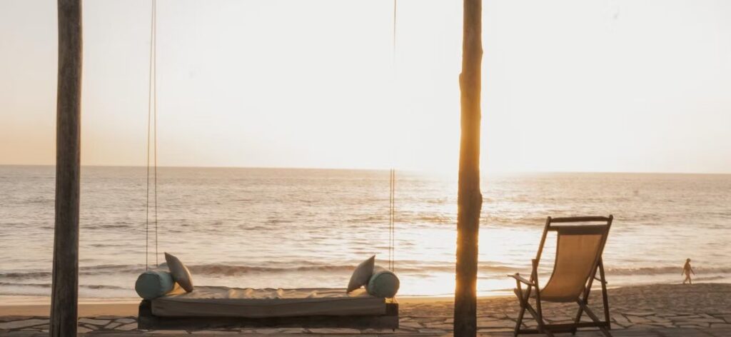 Beautiful swinging bed on the beach of El Transito, Nicaragua at sunset